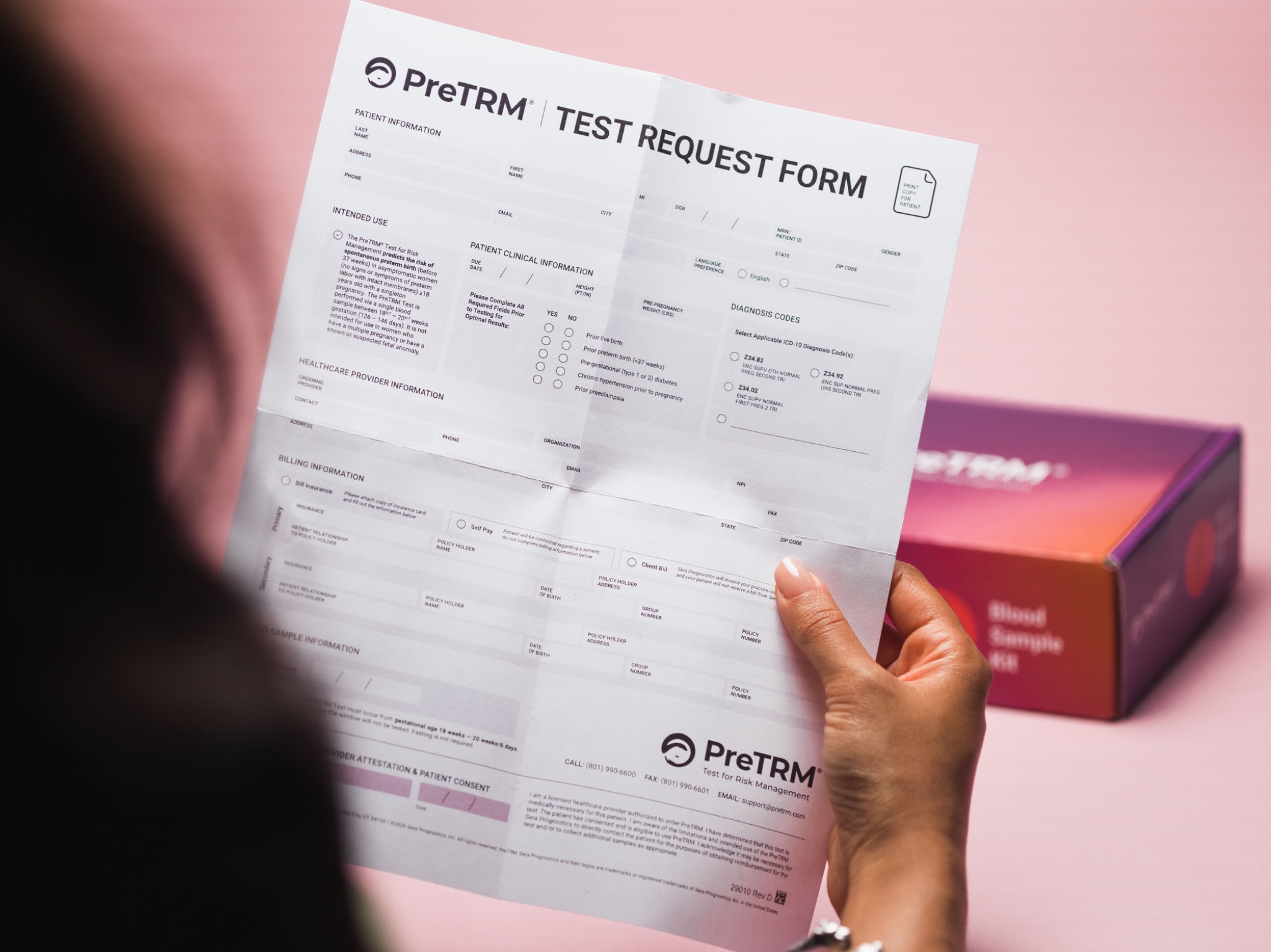Over-the-shoulder view of the PreTRM test request form and package