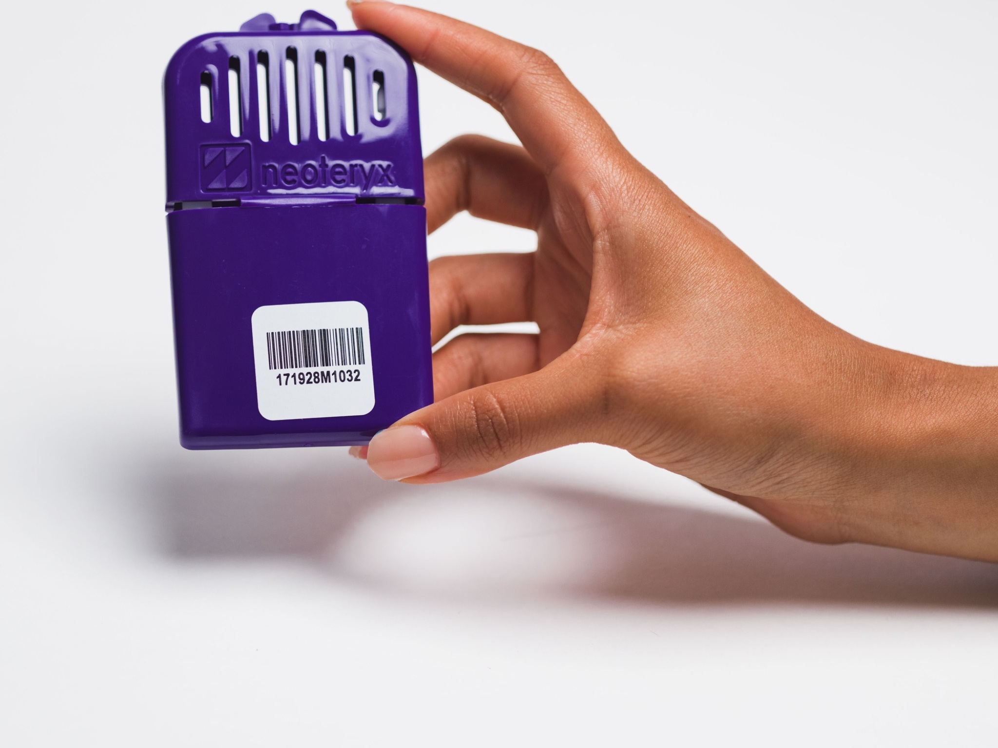 PreTRM sample component held in a hand against white