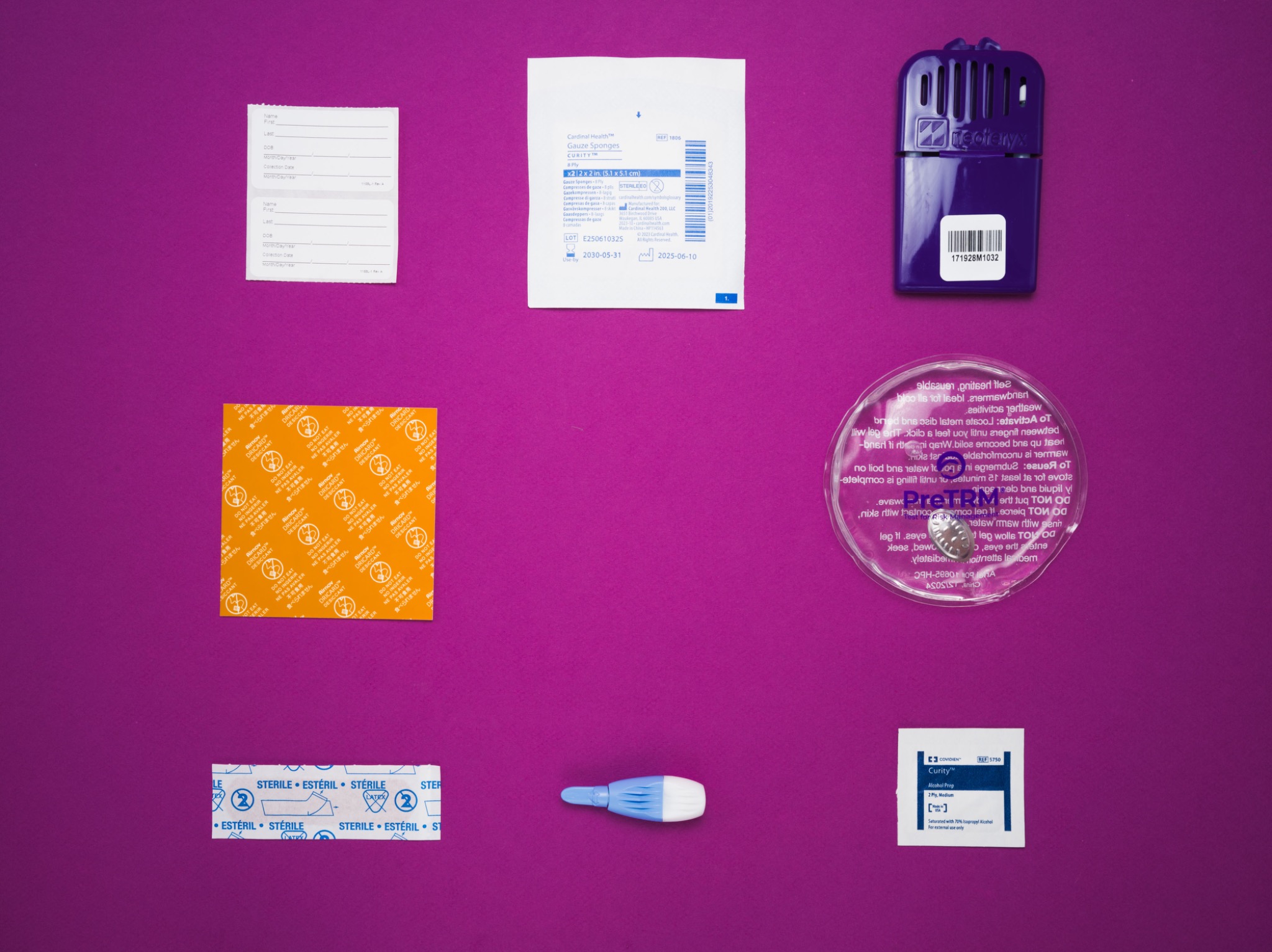 Complete PreTRM kit contents organized across a magenta surface