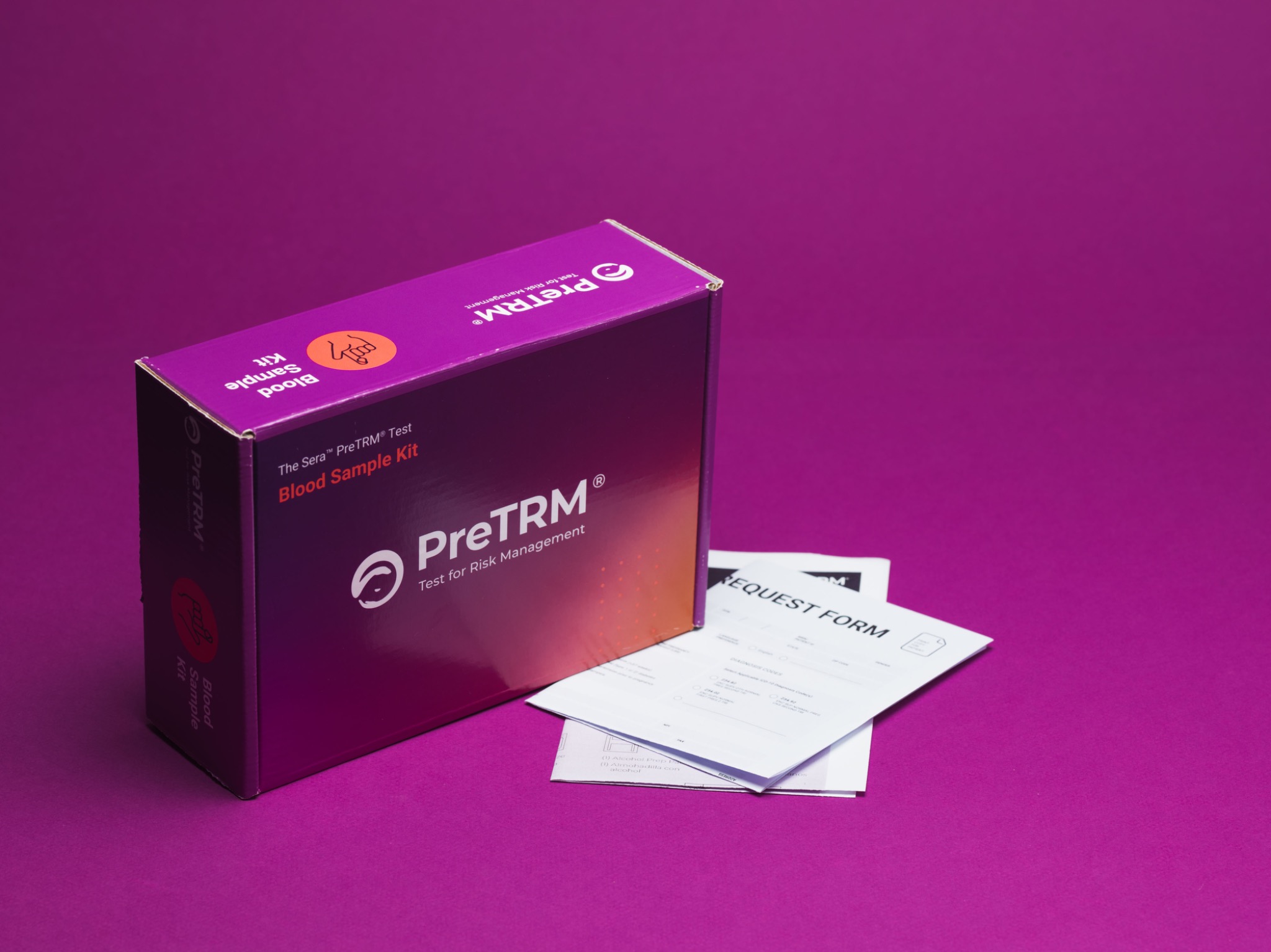 PreTRM blood sample kit styled with its test request forms on magenta